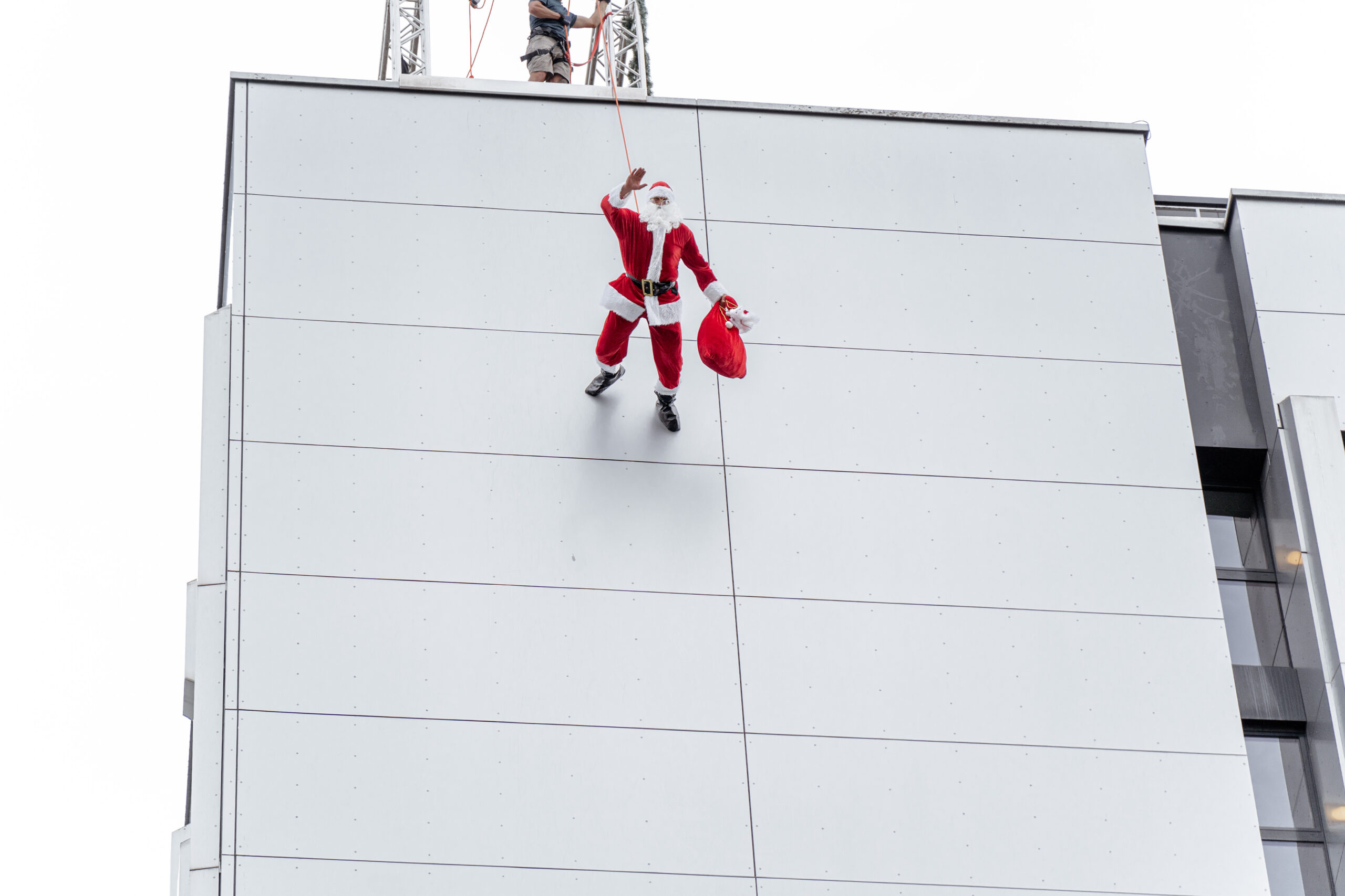 santa with his bag, running down a wall
